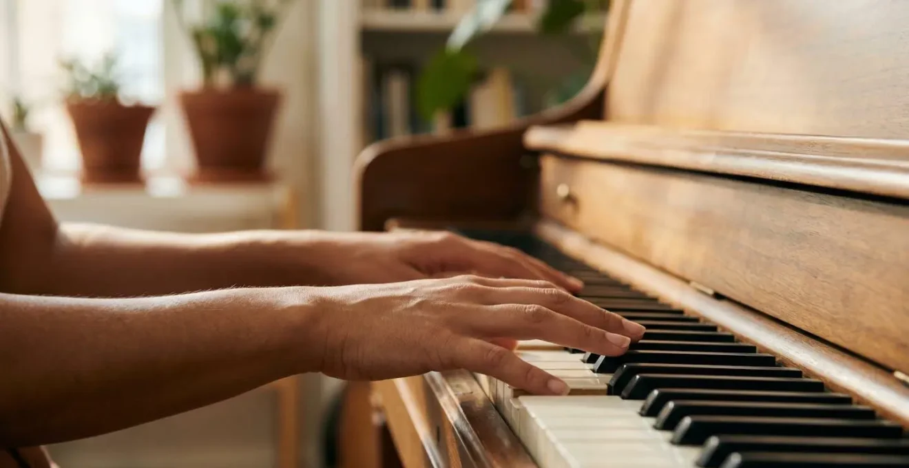 Close-up of relaxed hands on piano keys in natural light, capturing emotional connection with music