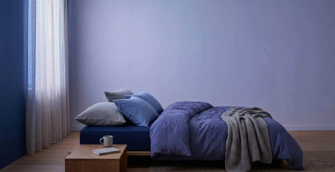 Serene sleeping environment bathed in soft twilight tones, representing optimal conditions for delta wave sleep induction