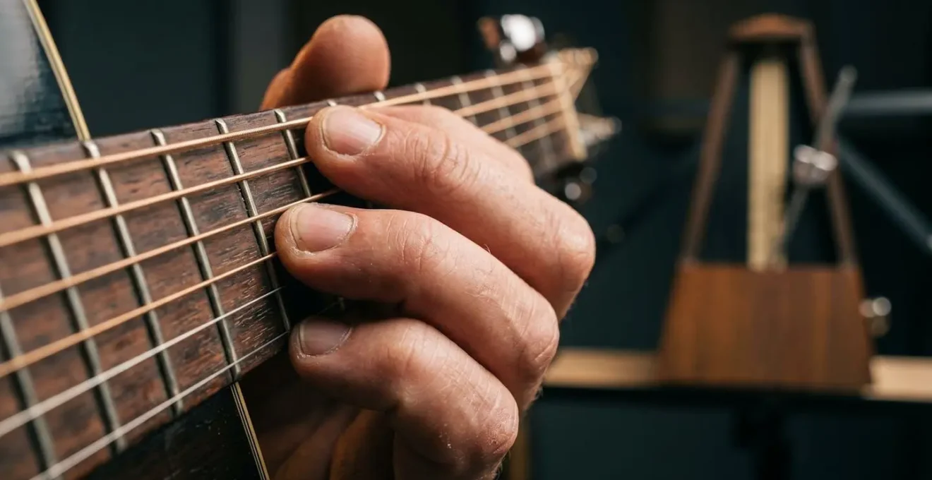 Close-up view of musician's hands practicing with selective metronome awareness