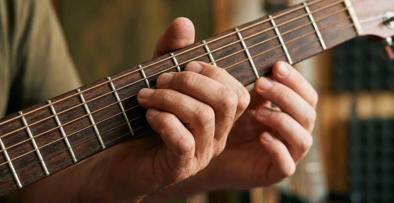 Close-up of hands demonstrating a musical technique with another set of hands mirroring the learning process