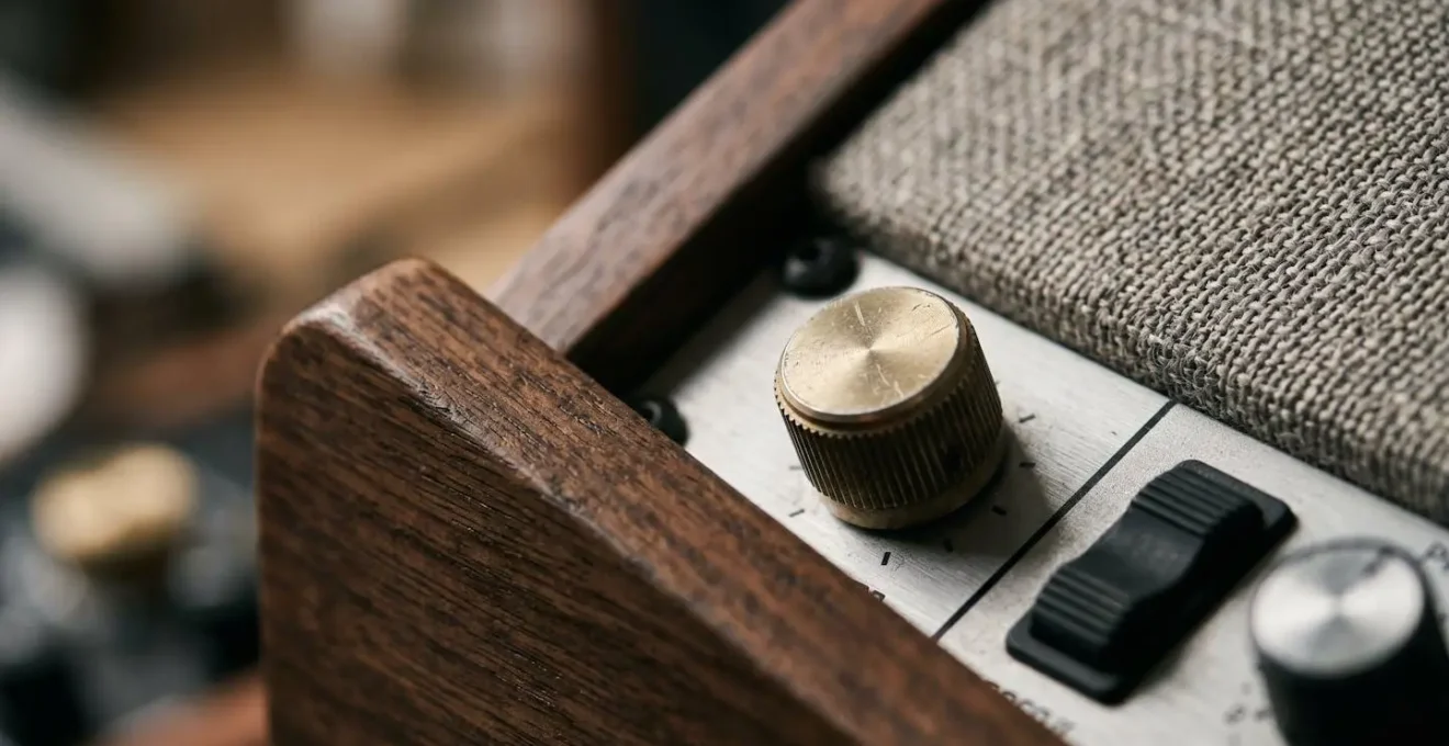 Close-up detail of metronome device and analog recording equipment in intimate home recording setting