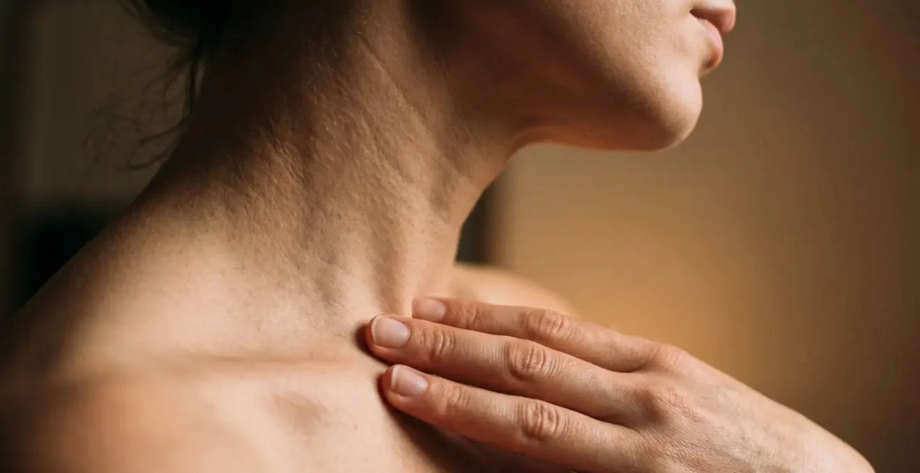 Close-up of human throat and chest area showing subtle vibration during vocalization